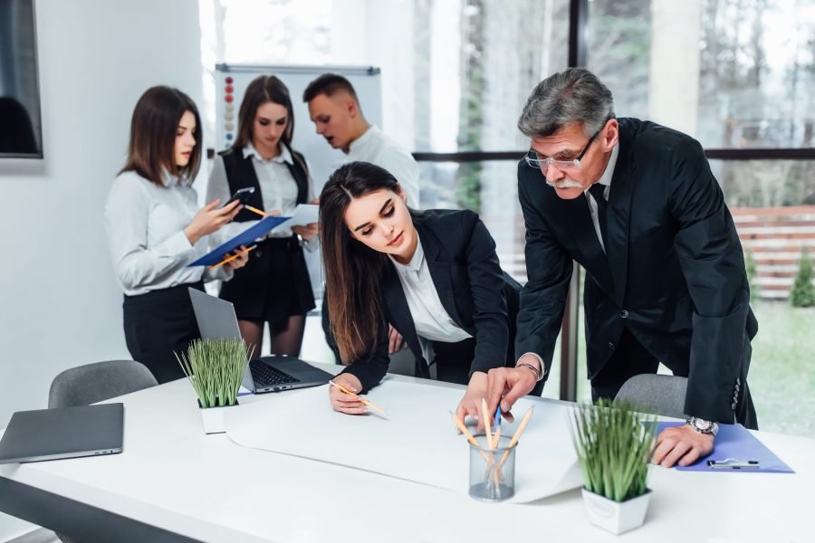 young-business-people-painting-writing-modern-office-space (1)